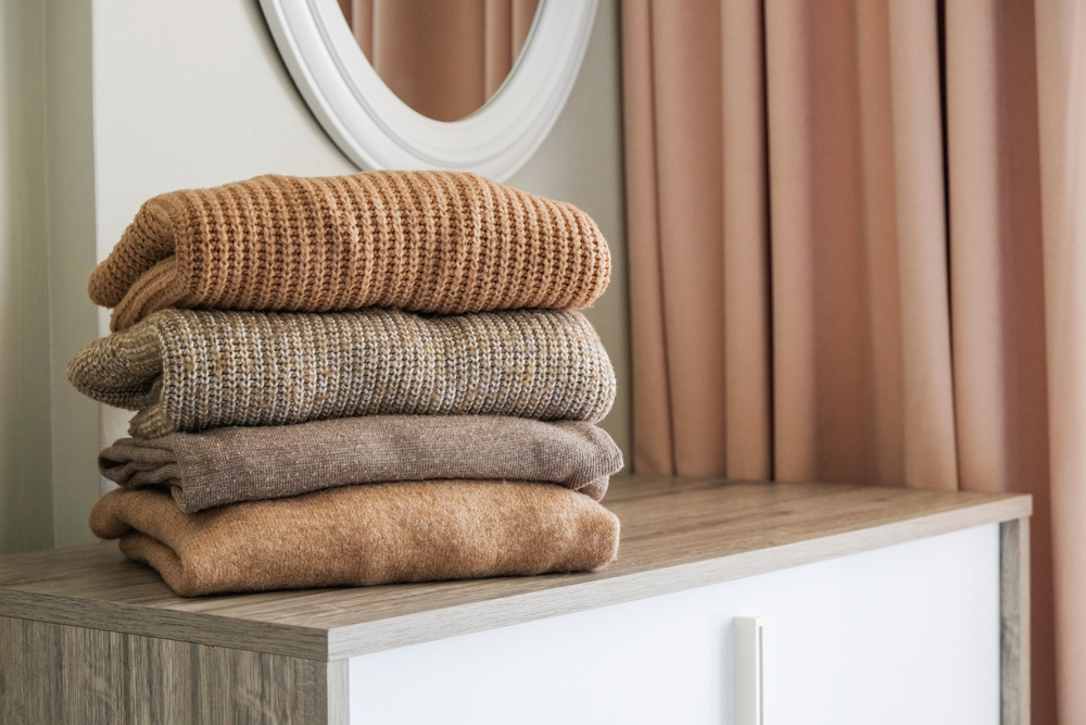 "Close-up of soft wool and cashmere fabrics stacked neatly, ideal for cool-weather fashion