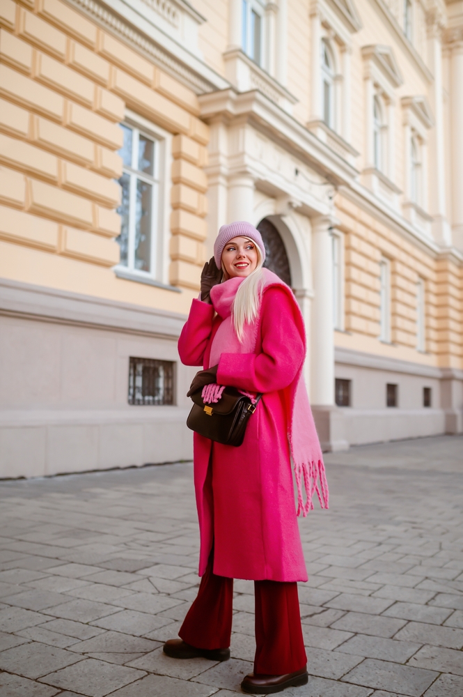 A cozy winter outfit with a chunky knit scarf, leather gloves, and a wool beanie.