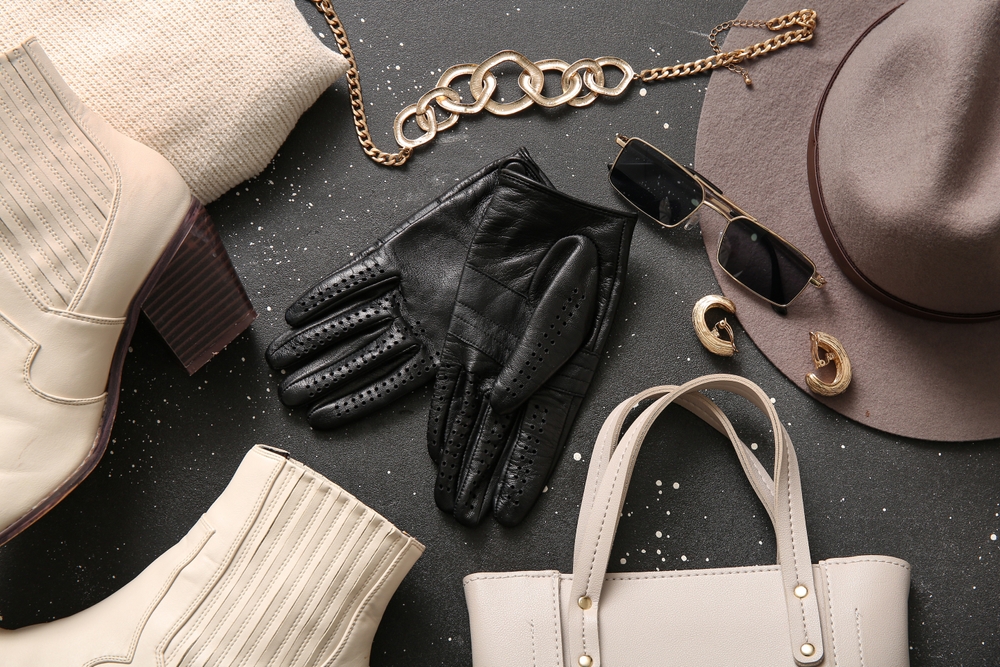 Trendy seasonal accessories like colorful handbags and statement necklaces displayed next to timeless basics.